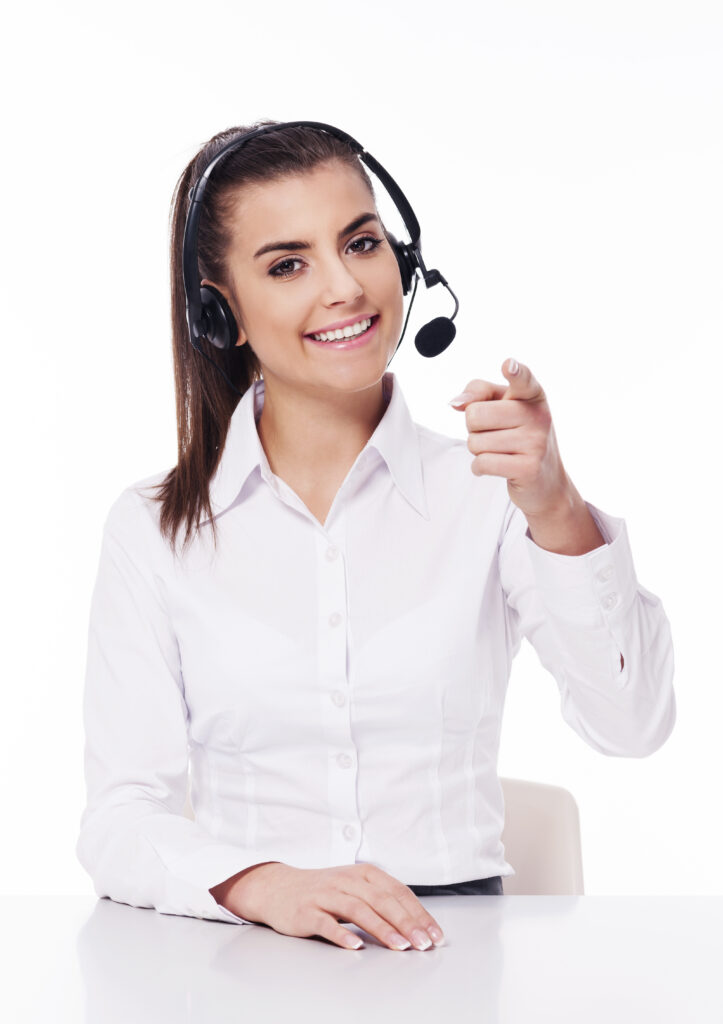 Woman with headset pointing at you